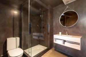 a bathroom with a shower and a toilet and a sink at Aspasios Born in Barcelona +11 photos