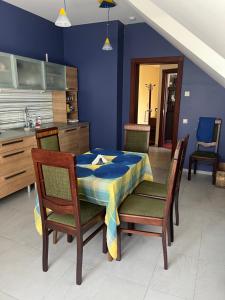 a dining room with a table and chairs in a kitchen at Classic Car Museum Apartment in Riga +18 photos