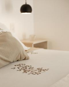 a bed with a pillow with a flower pattern on it at Yatay in Goya