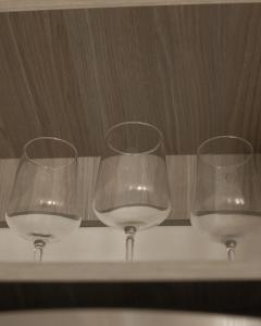 three wine glasses sitting on top of a shelf at Yatay in Goya +34 photos