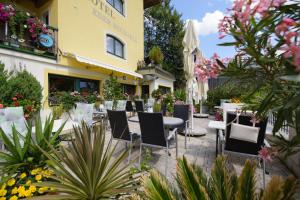 a patio with tables and chairs in front of a building at Hotel Eder Michaela in Saalbach-Hinterglemm