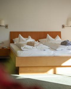 two beds in a hotel room with white sheets at Wellnesshotel Linde in Sulzberg +35 photos