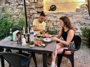 a man and a woman sitting at a table eating food at Cozy loft, Loire et chateaux in Messas +24 photos