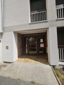 a building with a large doorway with a door at A350 Suites - Appartement climatisé, 2 chambres in Colomiers