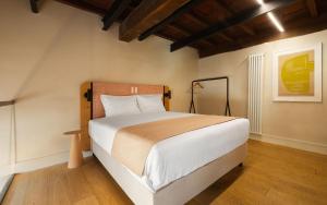 a bedroom with a large bed in a room at Limehome Rome Trastevere in Rome
