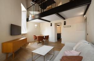 a living room with a couch and a table at Limehome Rome Trastevere in Rome +25 photos