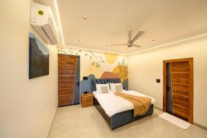 a bedroom with a bed and a ceiling fan at Earth by The StayCationer in Dehradun +57 photos
