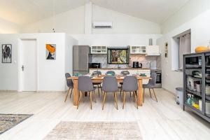 a kitchen and dining room with a table and chairs at Villa Taxiarchis by Corfuescapes in Benitses