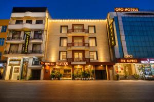 a building on a city street at night at The Waves Hotel with Free Airport Pickup or Drop in New Delhi