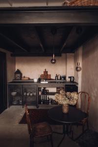 a kitchen with a table and chairs and a stove at Maruse's Apartment in Kuldīga