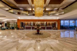 a lobby of a hotel with a chandelier at Pestana Carlton Madeira Ocean Resort Hotel in Funchal +49 photos