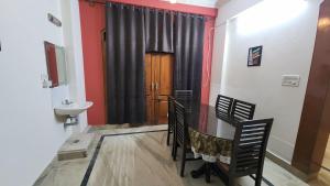 a dining room with a table and chairs and a sink at BMK Inn in Bangalore
