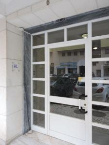 a door to a parking lot with cars in it at Comfort Rooms Near Lisbon Airport - Carlotta Living in Lisbon