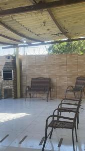 two benches sitting on a patio in a building at MT Laser casa 2 in São José da Coroa Grande