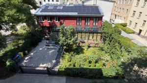 an aerial view of a building with a solar roof at Szmulson in Warsaw