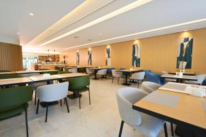 a dining room with tables and chairs in a restaurant at Staybridge Suites Beirut by IHG in Beirut