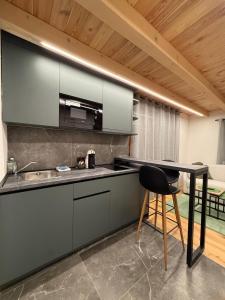 a kitchen with a counter and a stool in a room at Stella Alpina in Žabljak