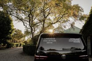a van parked on a road with the back at Maple & Rubus, Berry - by Linnaeus Collection in Berry