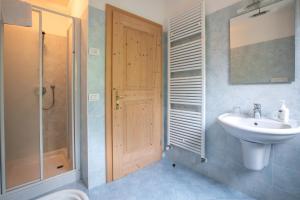 a bathroom with a sink and a toilet and a shower at Ciesa Al Drago in Rocca Pietore