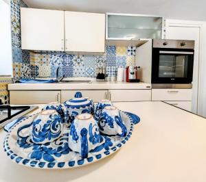 a kitchen with blue and white dishes on a counter at Rifugio Caretta in Montecorice +19 photos
