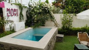 a swimming pool in a backyard with a garden at Otla - A Heritage Boutique Hotel, Jaipur in Jaipur