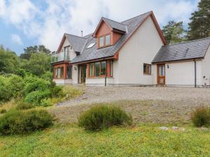 a house on a hill with a yard at Thistle Do in Lochailort