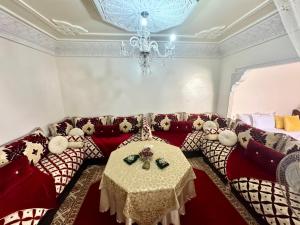 a living room with a couch and a table at Romantic apartment near sea in Safi, Morocco in Safi
