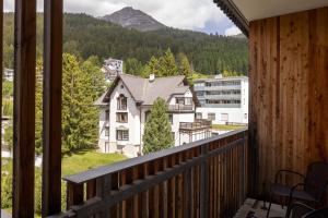 a balcony with a view of a building and a mountain at Hilton Garden Inn Davos in Davos