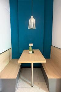 a table with a cactus on it in a room at GoStay Pods at Perak Road in Singapore +27 photos