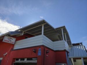 a red and white building with a sign on it at Rooms Jelak in Velika Gorica