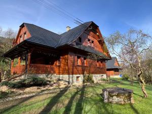 a large wooden house with a black roof at Chata Pod Kohůtkou in Nový Hrozenkov