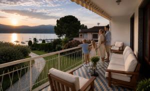 a family standing on the balcony of a house at Ranco Villa Lina in Ranco