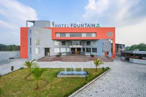 a hotel courtyard with a building in the background at Hotel Fountain - Kamrej in Surat