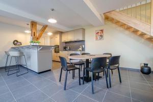 a kitchen and dining room with a table and chairs at Numéro 3 in Morvilliers