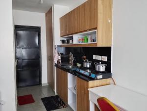 a small kitchen with a stove and a refrigerator at Tsavo in Nairobi