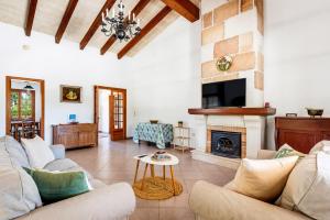 a living room with a couch and a fireplace at Casa Carlos - Villa en Son Cabrises in Cala Blanca