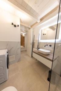 a bathroom with a sink and a mirror at Luma Apartment Sperlonga in Sperlonga +25 photos