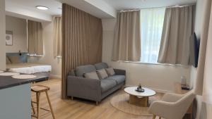 a living room with a couch and a bed at AH Residence Anička in KoÅ¡ickÃ© KÃºpele