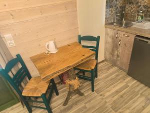 a wooden table and chairs in a kitchen at Alexandros and Georgia in Ipsos