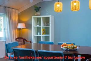 a dining room with a table and a bowl of fruit at opdehoekvandestal in Workum