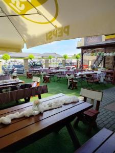 a patio with tables and benches and an umbrella at Mattes Restaurant & Pension in Držovice
