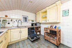 a kitchen with white cabinets and a sink at Ferienhaus Sternenklar in Wittmund