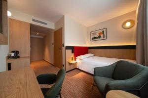 a hotel room with a bed and a table and chairs at Qubus Hotel Gliwice in Gliwice +49 photos