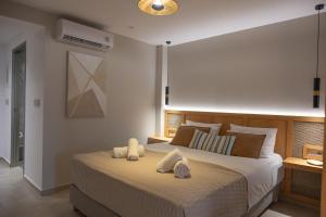 a bedroom with a large bed with towels on it at Villa Maraki in Agia Paraskevi +49 photos