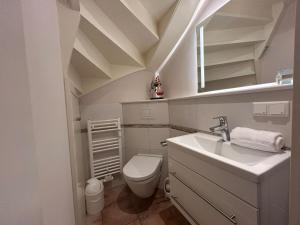 a small bathroom with a sink and a toilet at Inseltraum in Wrixum