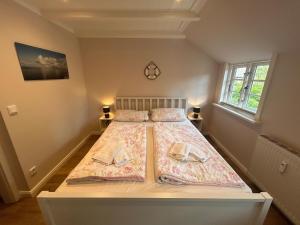 a bedroom with a bed with two pillows on it at Inseltraum in Wrixum +3 photos