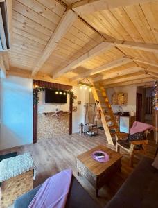 a living room with a wooden ceiling and a wooden table at Mountains story in Bistrica Lipovska