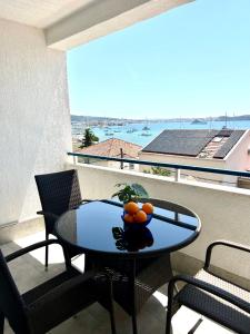 a table with a bowl of oranges on a balcony at Villa Bavaria Trogir in Trogir
