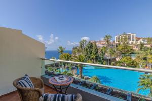 a balcony with a view of the ocean at Pestana Carlton Madeira Ocean Resort Hotel in Funchal