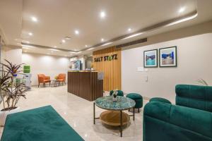 a waiting room with a couch and a table at Saltstayz Select- Medicity Near Medanta Hospital in Gurgaon